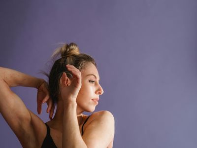 Blurred motion of a person performing a graceful stretch.