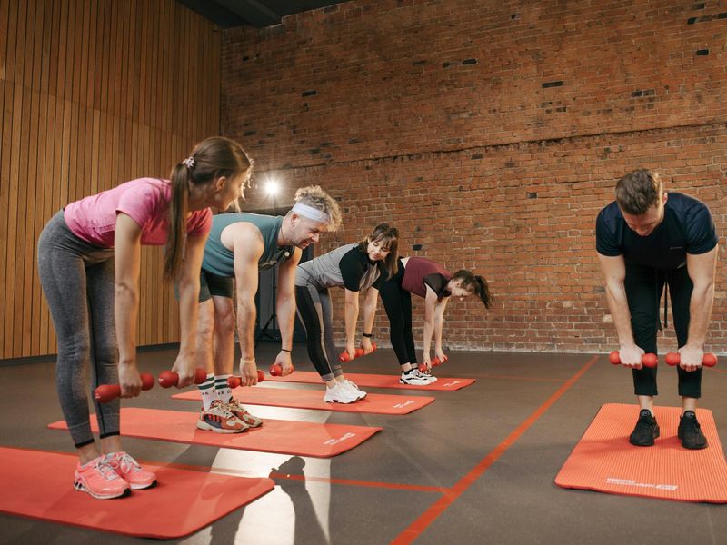 Minimalist yoga studio with warm amber lighting and mats.